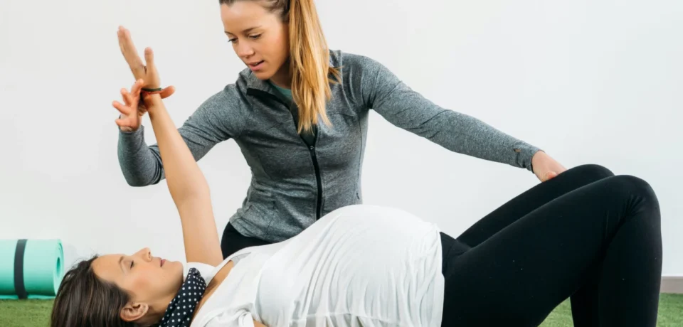 Therapist helping woman do physiotherapy in Vancouver's Olympic Village