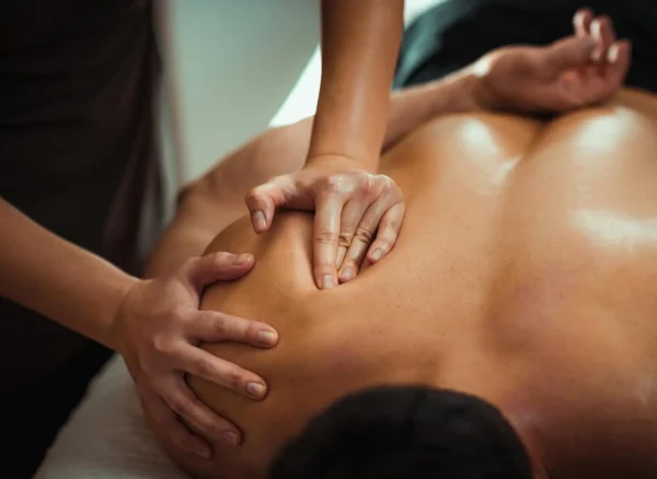 massage therapist working on patient